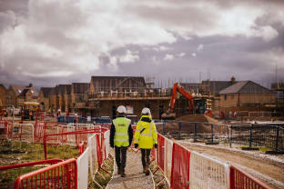 Two people on a construction site